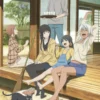 Group of friends relaxing on the veranda with tea, a cat nearby, enjoying countryside life.