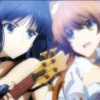 Setsuna Ogiso singing with a microphone while Kazusa Touma plays guitar.