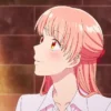 Narumi Momose smiling warmly under soft light with a blush on her face.